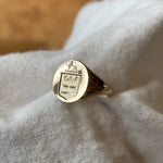 14k solid yellow gold signet ring with bespoke engraving. Custom family crest design.